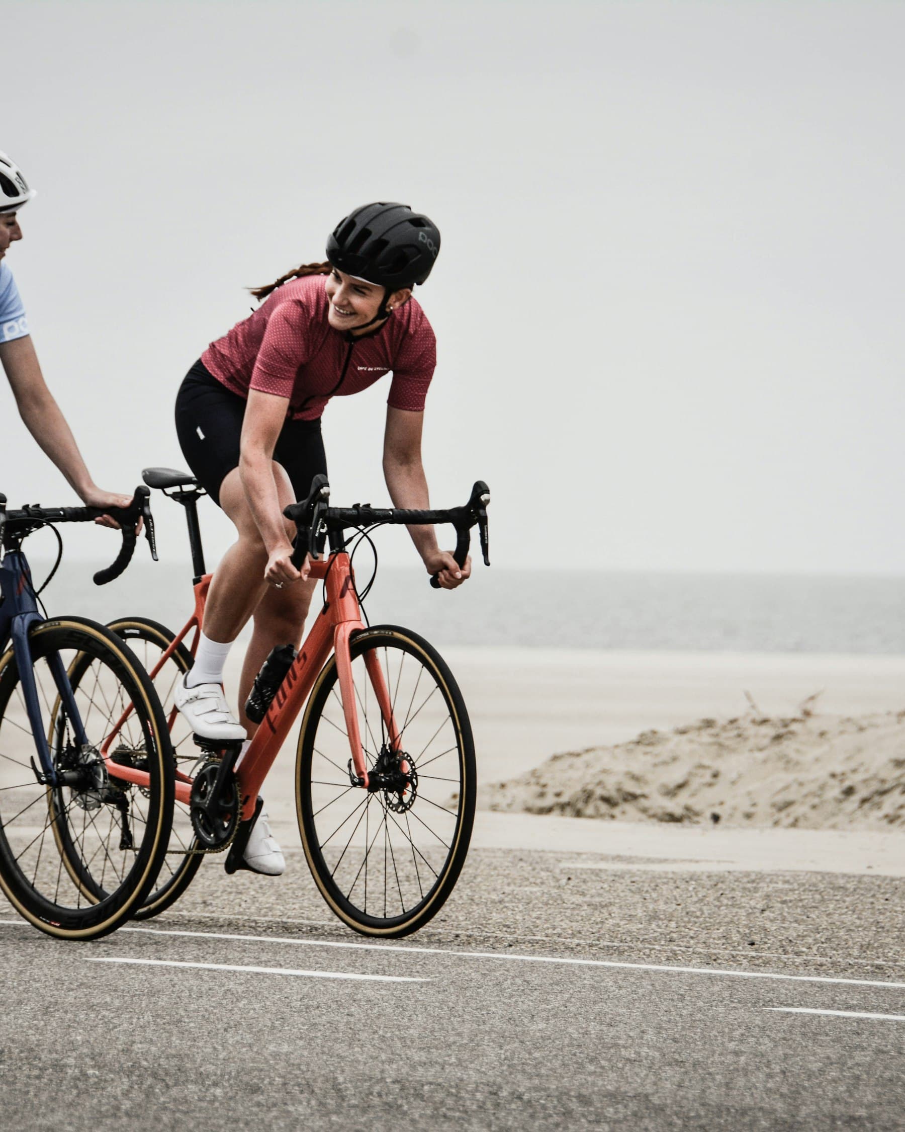 Two riders training together on an open coast road