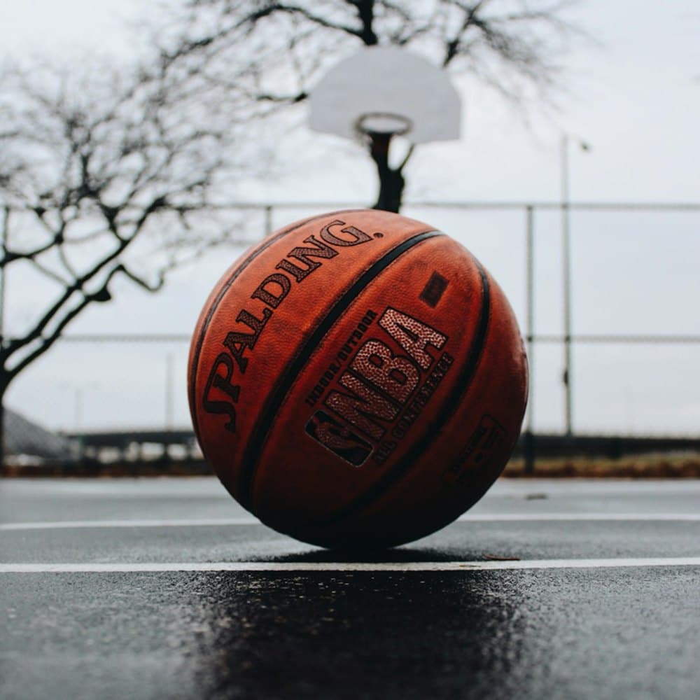 Basketball resting on wet ground after a session