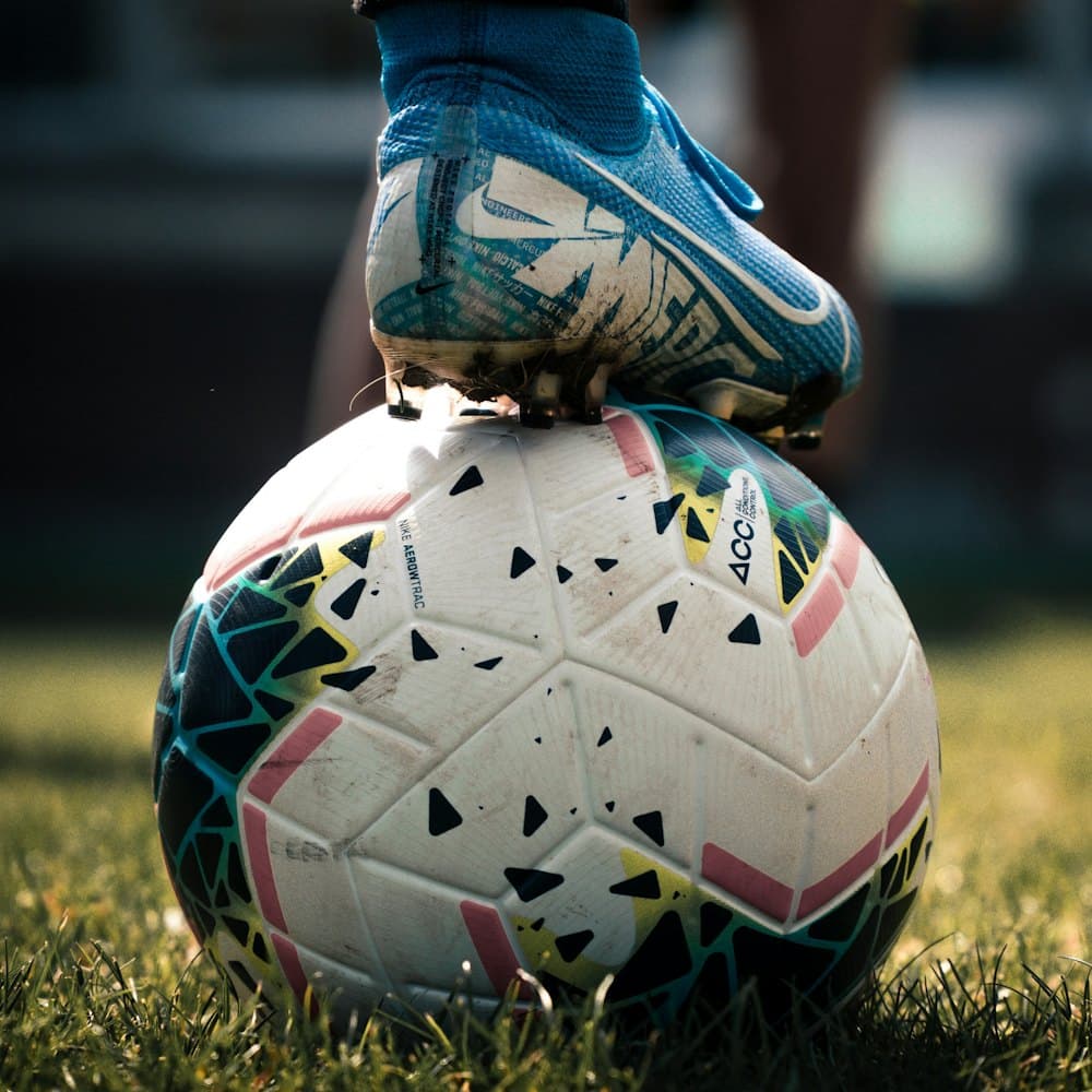 Football and boot on the pitch before kickoff