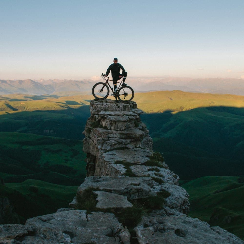 A cyclist at the top of a hill climb