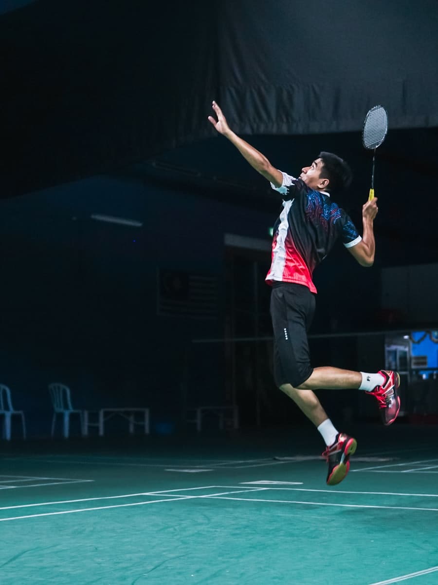 Badminton player leaping into a smash