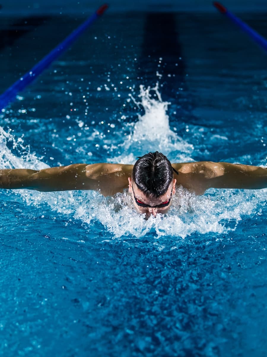 Swimmer mid-stroke in a competition pool